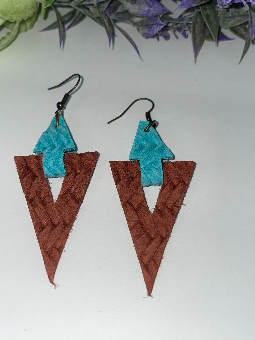 Turquoise and rustic orange leather arrow shaped earrings.